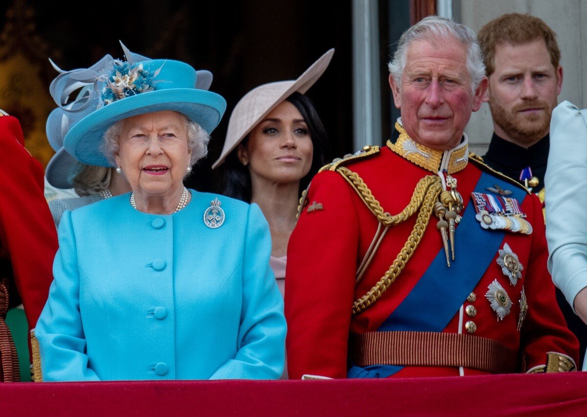 Queen Elizabeth II, then-Prince Charles, Prince Harry, and Meghan Markle during Trooping The Colour 2018
