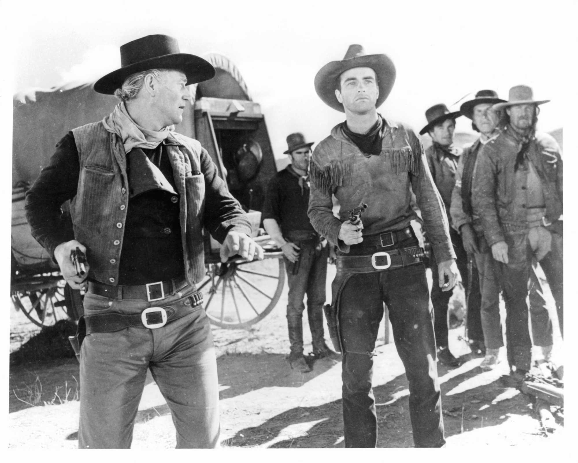 'Red River' John Wayne as Thomas Dunson and Montgomery Clift as Matt Garth. Dunson is looking at Garth, who is holding his pistol out.