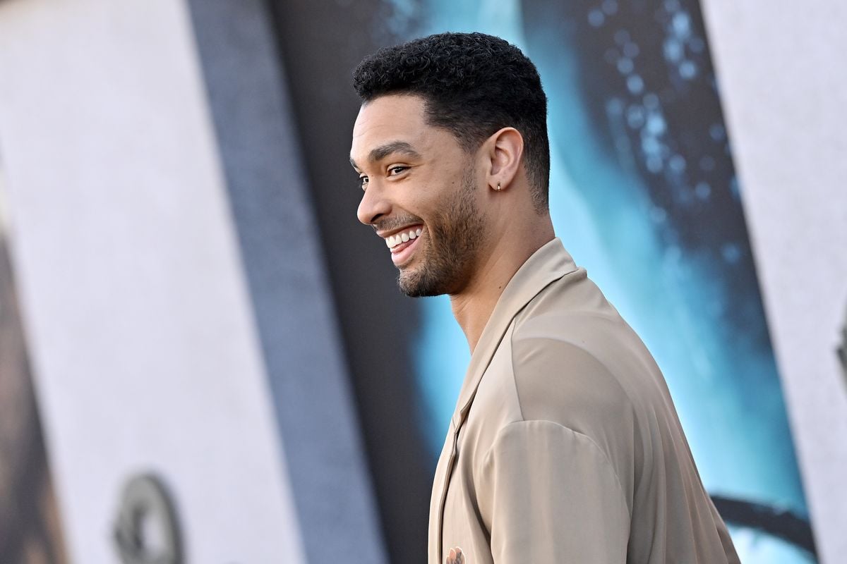 Regé-Jean Page smiles for photos at a movie premiere event.