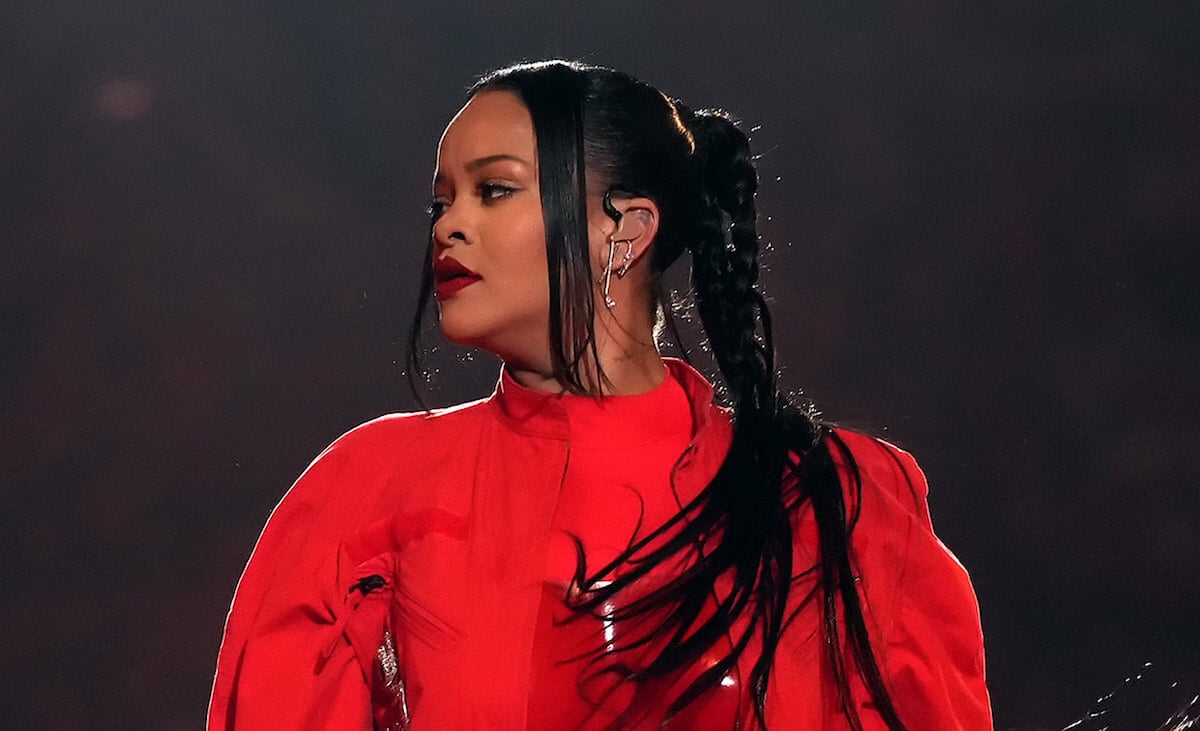 Rihanna wearing red with her face turned at the Super Bowl halftime show