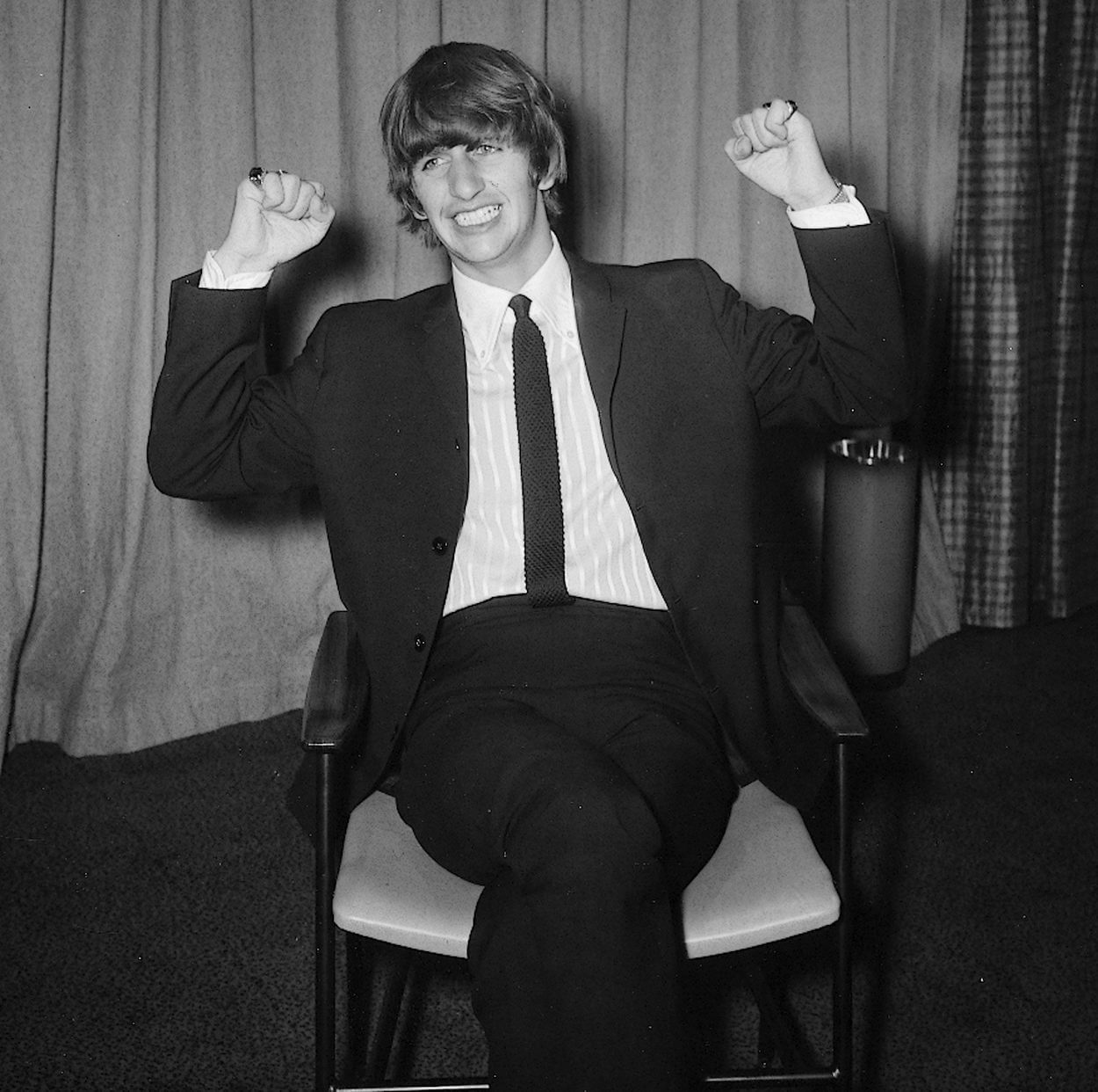 Ringo Starr wears a suit as he sits for a photo in February 1964.