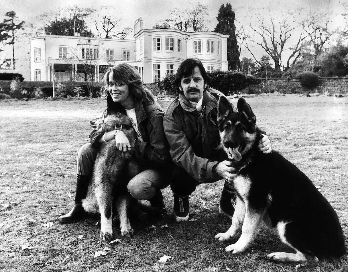 Barbara Bach (left), Ringo Starr, and their dogs pose on the lawn outside their house in 1981.