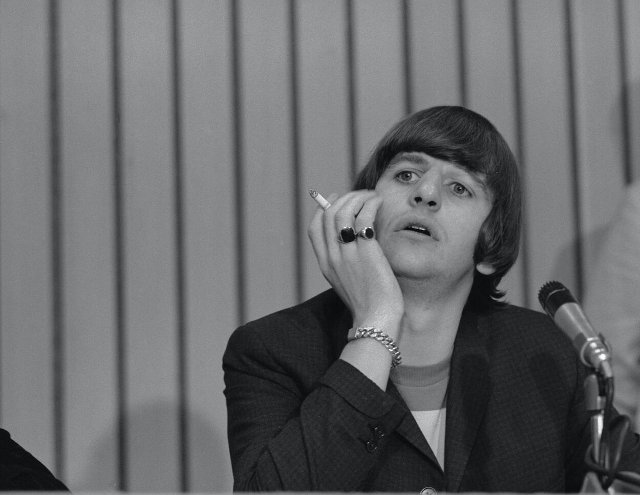 Ringo Starr holds a cigarette as he cups his face during a 1965 press conference before a Beatles concert.