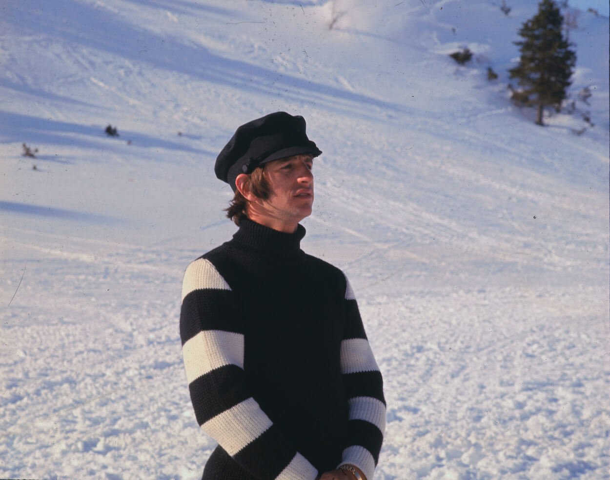 Ringo Starr stands on a ski slope while wearing a black and white striped sweater while filming 'Help!' in early 1965.