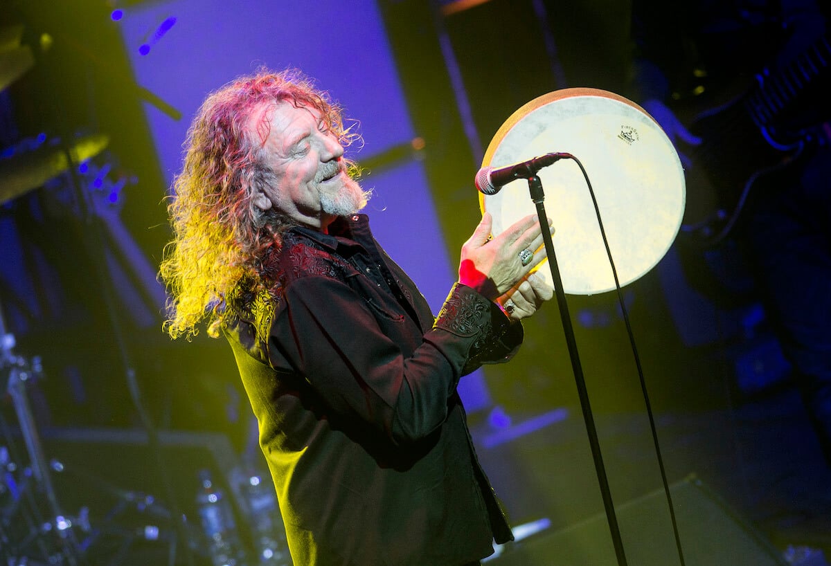 Robert Plant standing behind a microphone