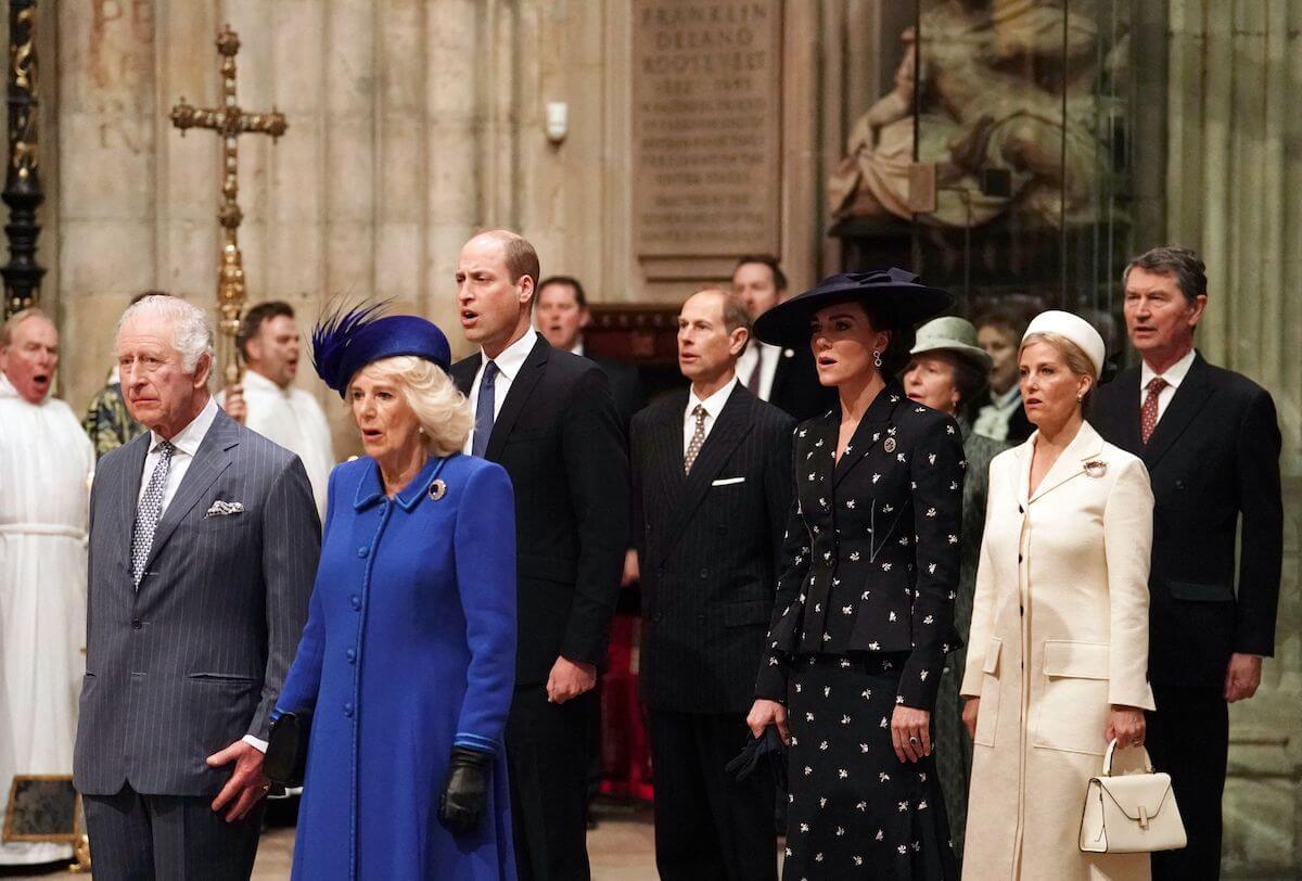 King Charles, who received a 'shoulder-bump' from Sophie, Duchess of Edinburgh, stands with Camilla Parker Bowles, Prince Edward, Prince William, Kate Middleton, Sophie, and other royals.