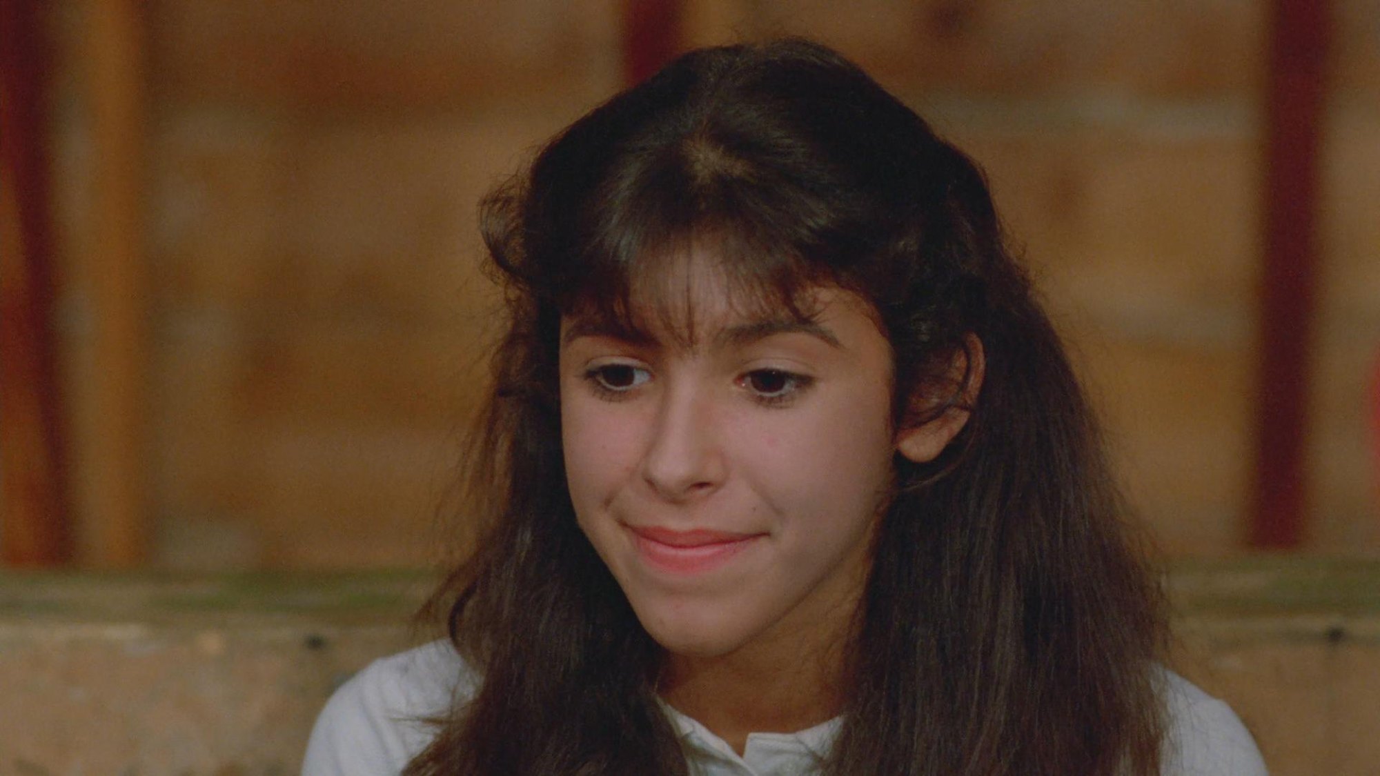 'Sleepaway Camp' Felissa Rose as Angela with a slight smile on her face, looking down.
