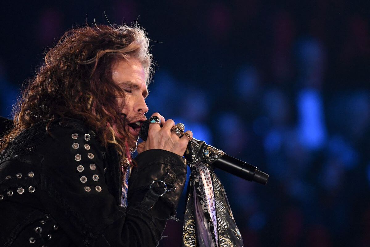 Steven Tyler of Aerosmith singing into a microphone