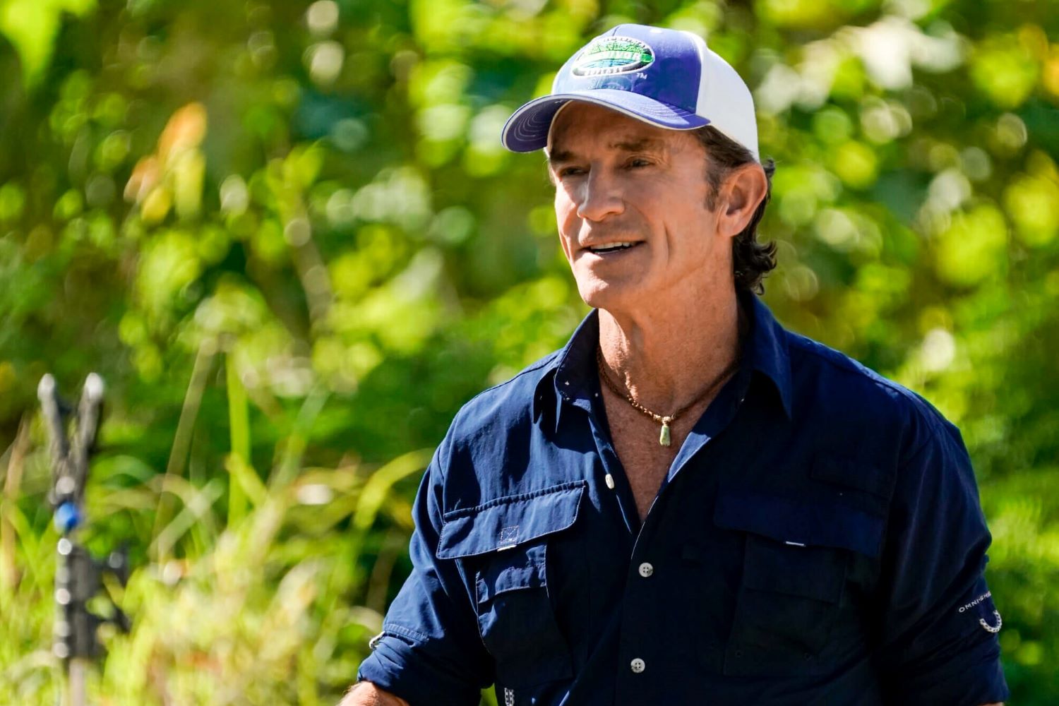 Jeff Probst, who recently confirmed 'Survivor' Season 44 showmance spoilers, wears a dark blue button-up shirt and a blue and white 'Survivor' baseball cap.