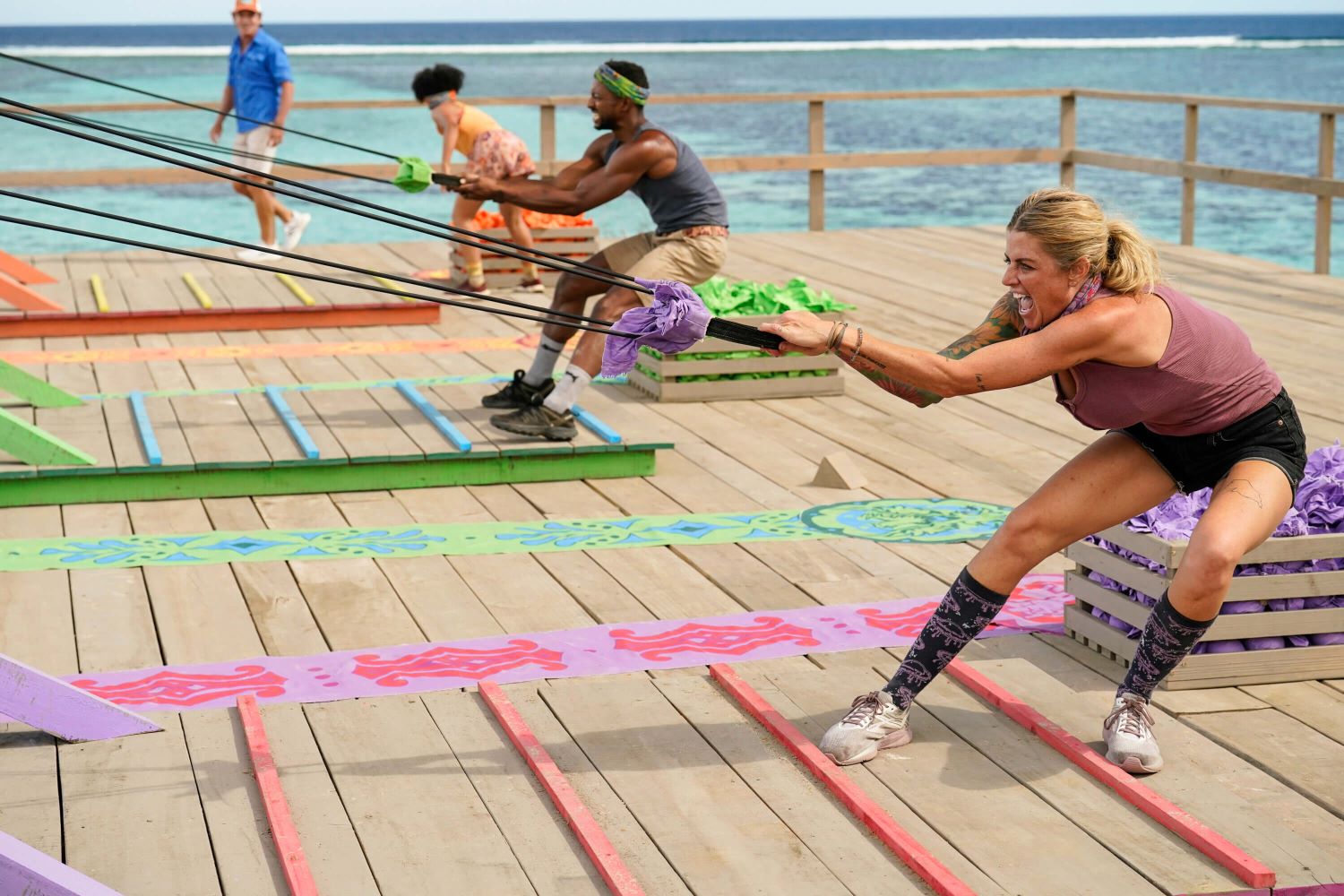 Lauren Harpe, Josh Wilder, and Carolyn Wiger compete in a Reward Challenge as host Jeff Probst looks on in 'Survivor 44' Episode 4 on CBS.