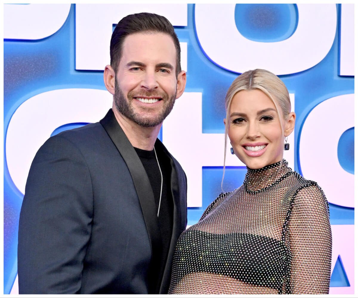 Tarek and Heather Rae El Moussa smile and pose together at an event.