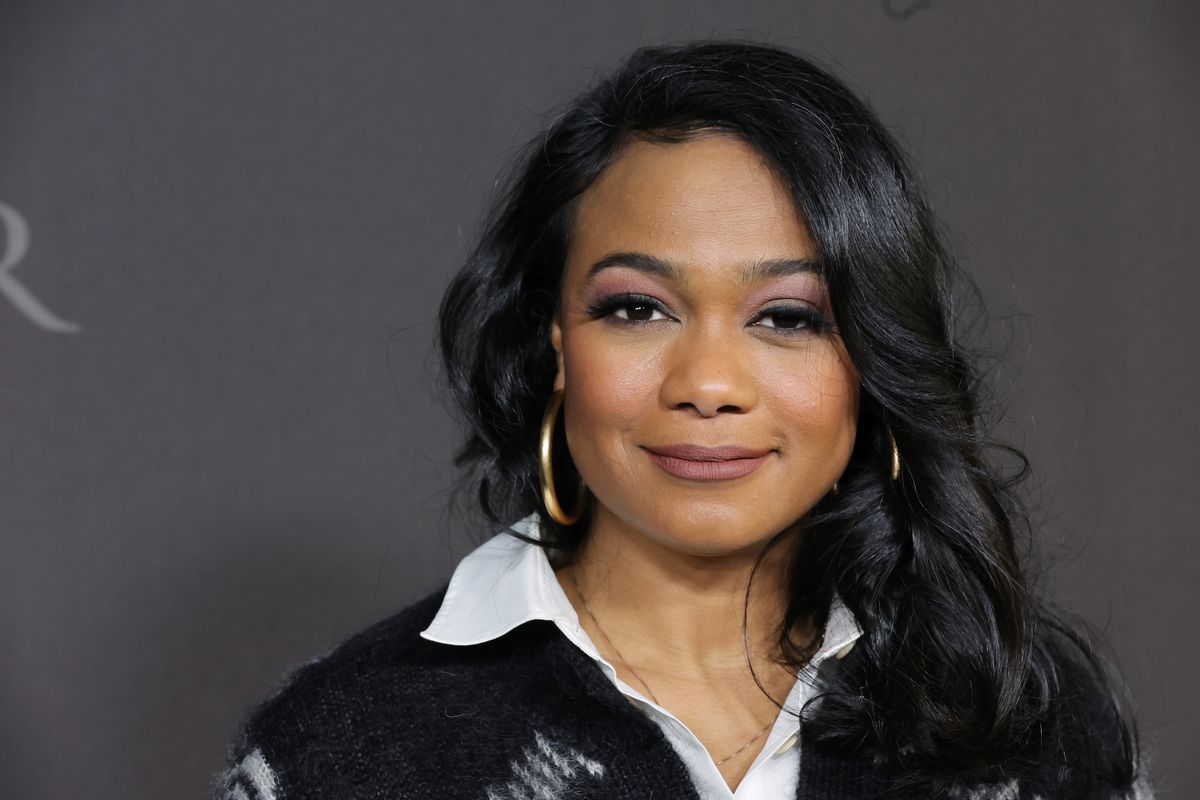 Tatyana Ali smiles at a premiere event for "Bel-Air"