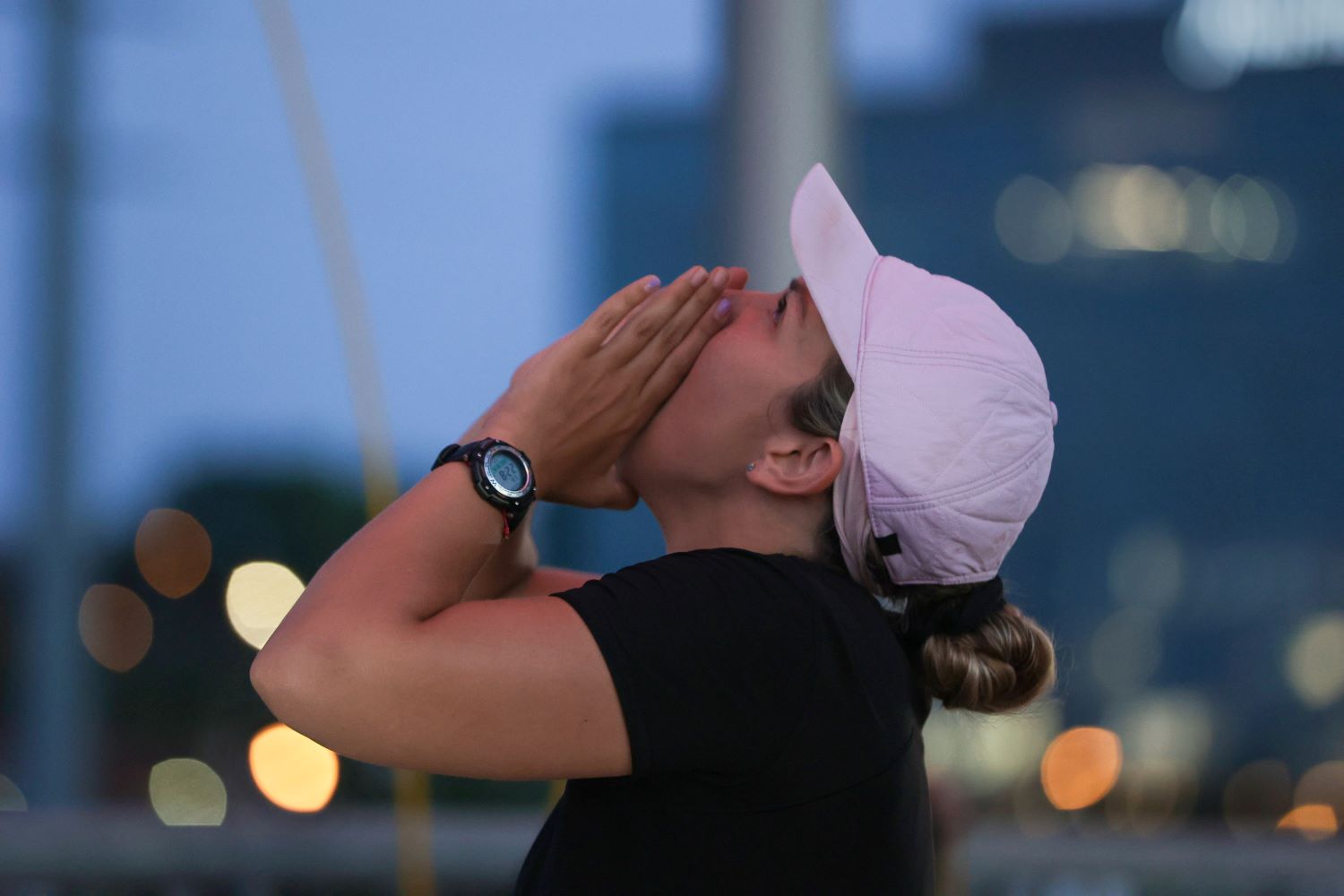 Claire Rehfuss, the winner of 'The Amazing Race 34' on CBS, wears a black shirt and light pink baseball cap during the final leg while calling up to her partner Derek Xiao.