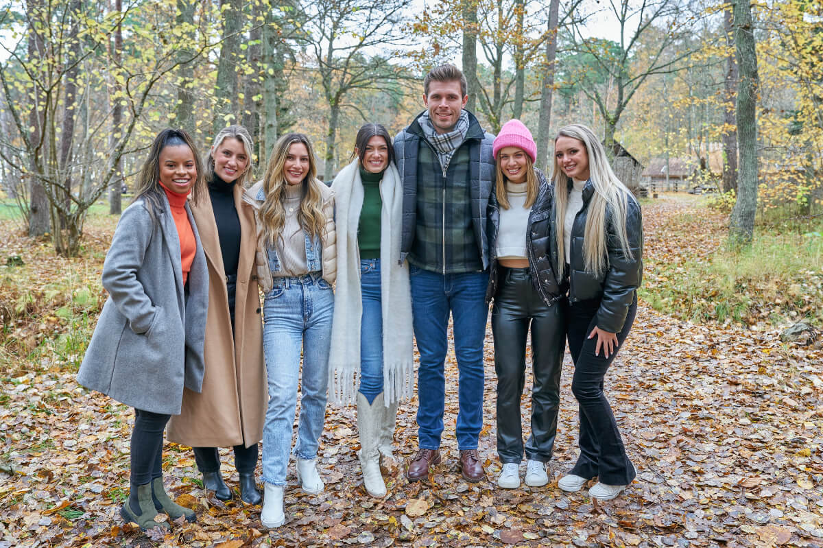 During The Bachelor Season 27 Week 6, Zach poses for a photo with the women during a group date in Tallinn, Estonia.