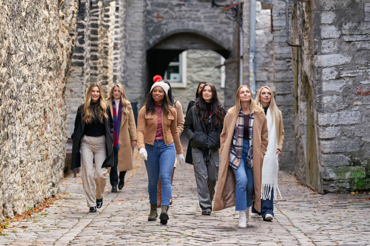 During The Bachelor Season 27, the women walk beside brick buildings in Tallinn, Estonia. 