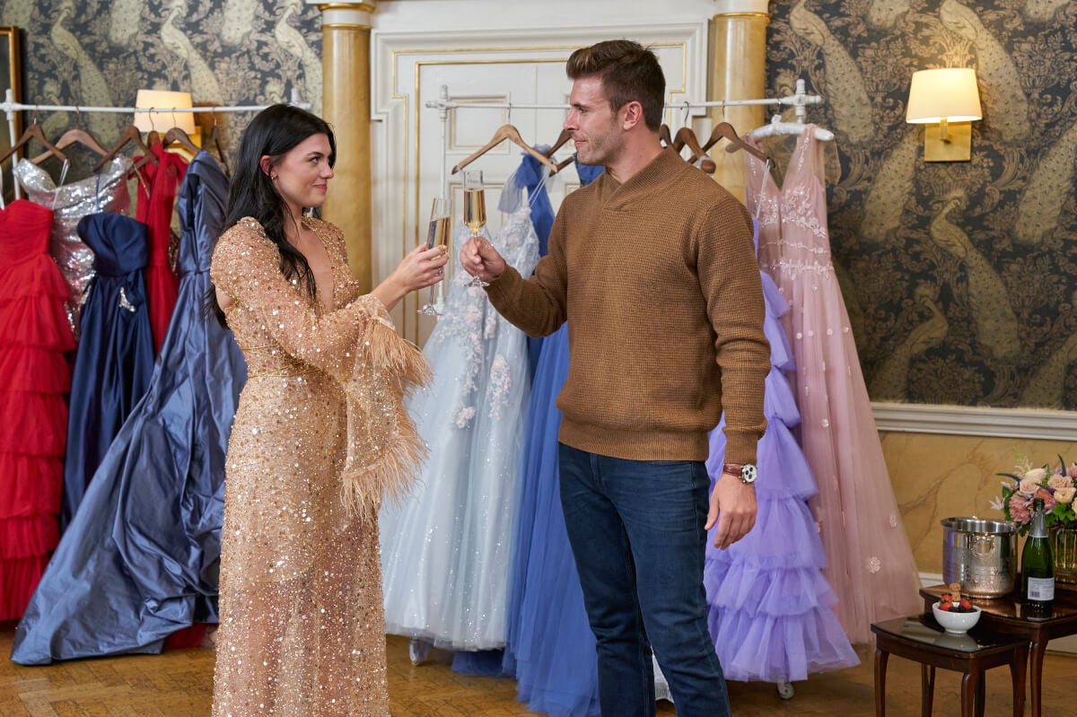 During The Bachelor Week 5, Zach takes Gabi on a shopping date. She tries on a nude sequined dress and toasts Zach with a glass of champagne.