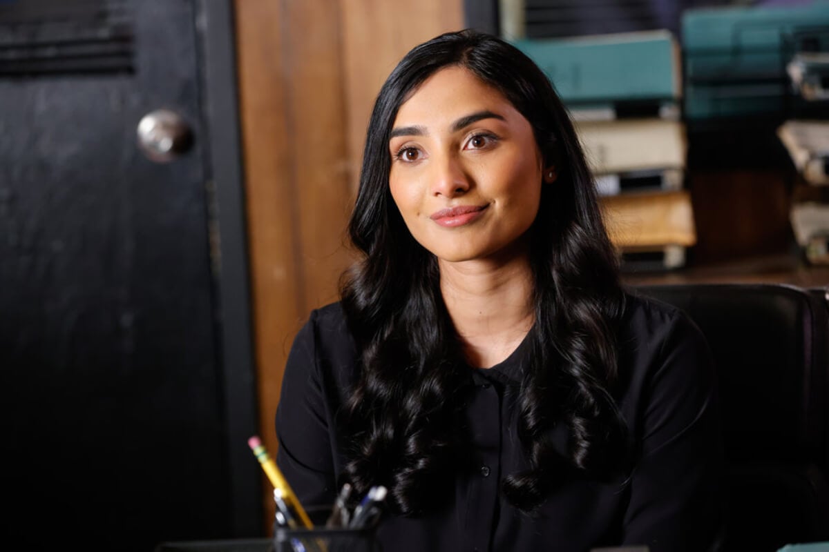 During The Blacklist Season 10, Siya Malik actor Anya Banerjee sits in cooper's office.