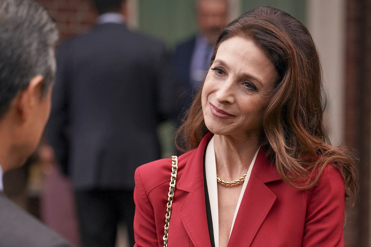 Marin Hinkle, in character as Claire Fox in 'The Company You Keep' Season 1 Episode 4, wears a red suit.