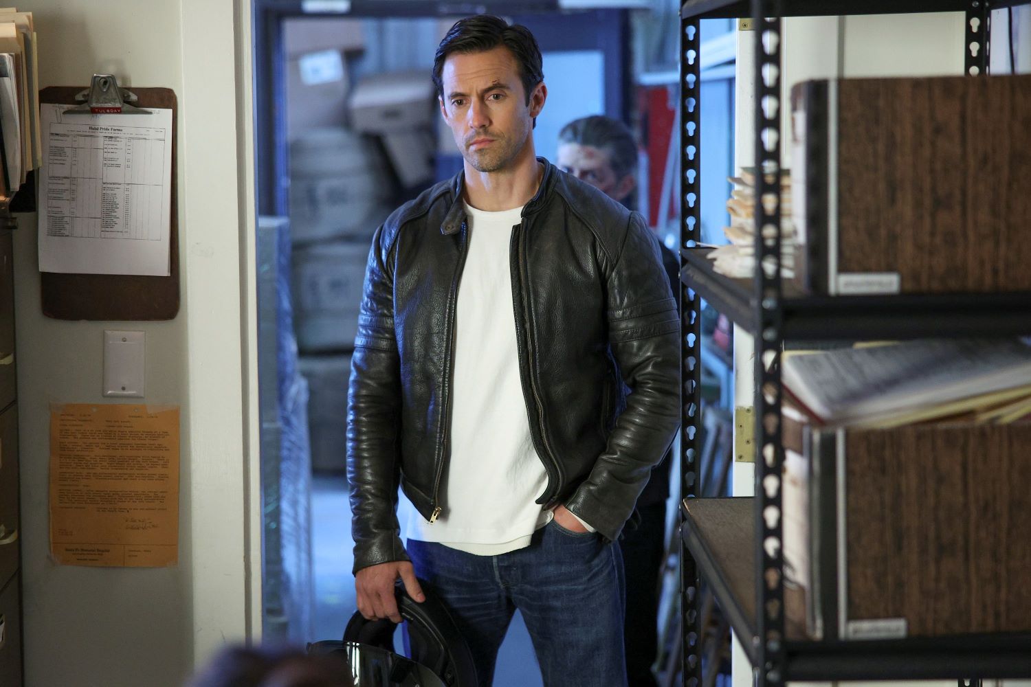 Milo Ventimiglia, in character as Charlie Nicoletti in 'The Company You Keep' Season 1 Episode 5, wears a black leather jacket over a white shirt and blue jeans.