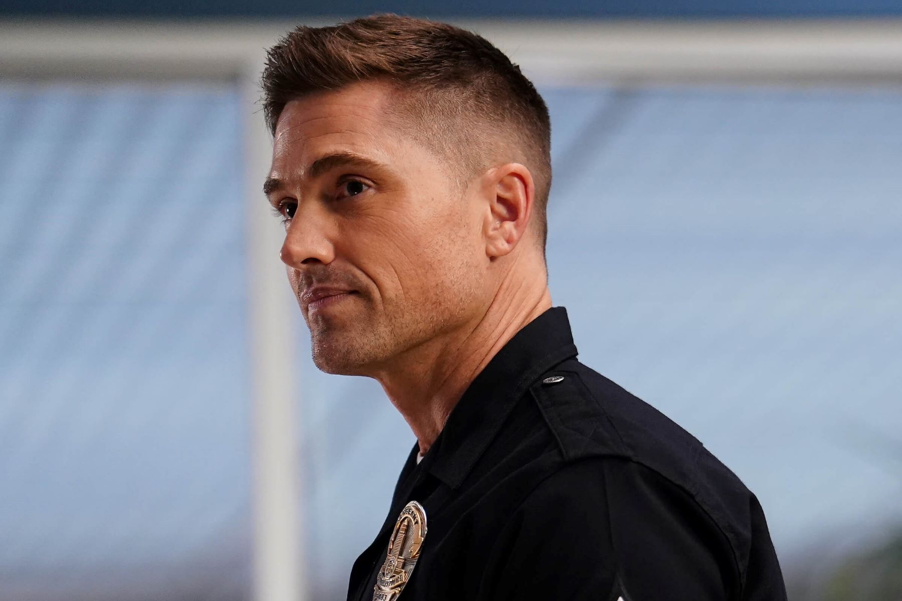 Eric Winter, who stars as Tim Bradford in 'The Rookie' Season 5 Episode 18, 'Double Trouble,' wears his dark blue police uniform.