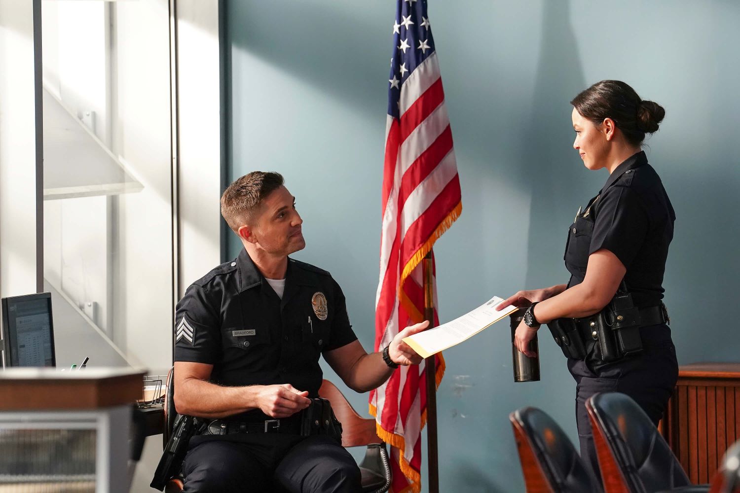 Eric Winter as Tim Bradford and Melissa O'Neil as Lucy Chen in 'The Rookie' on ABC, which has yet to be renewed for season 6. In the picture, Tim and Lucy wear their dark blue police uniforms.