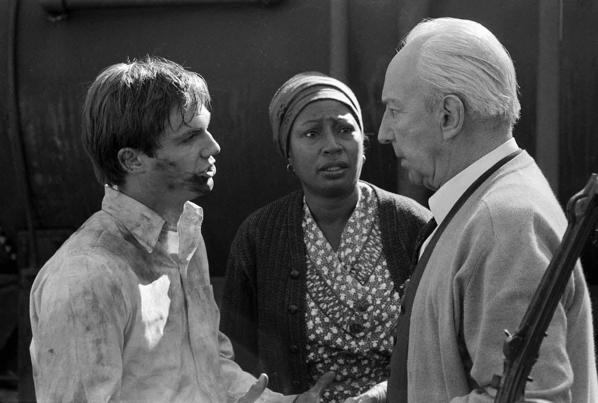 Black and white photo of Richard Thomas with Lynn Hamilton and Lloyd Nolan on 'The Waltons'
