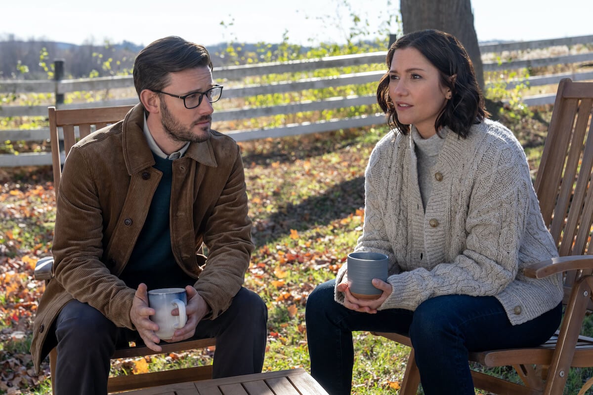 Evan Williams and Chyler Leigh sitting next to each other in 'The Way Home,' which has been renewed for season 2 by Hallmark