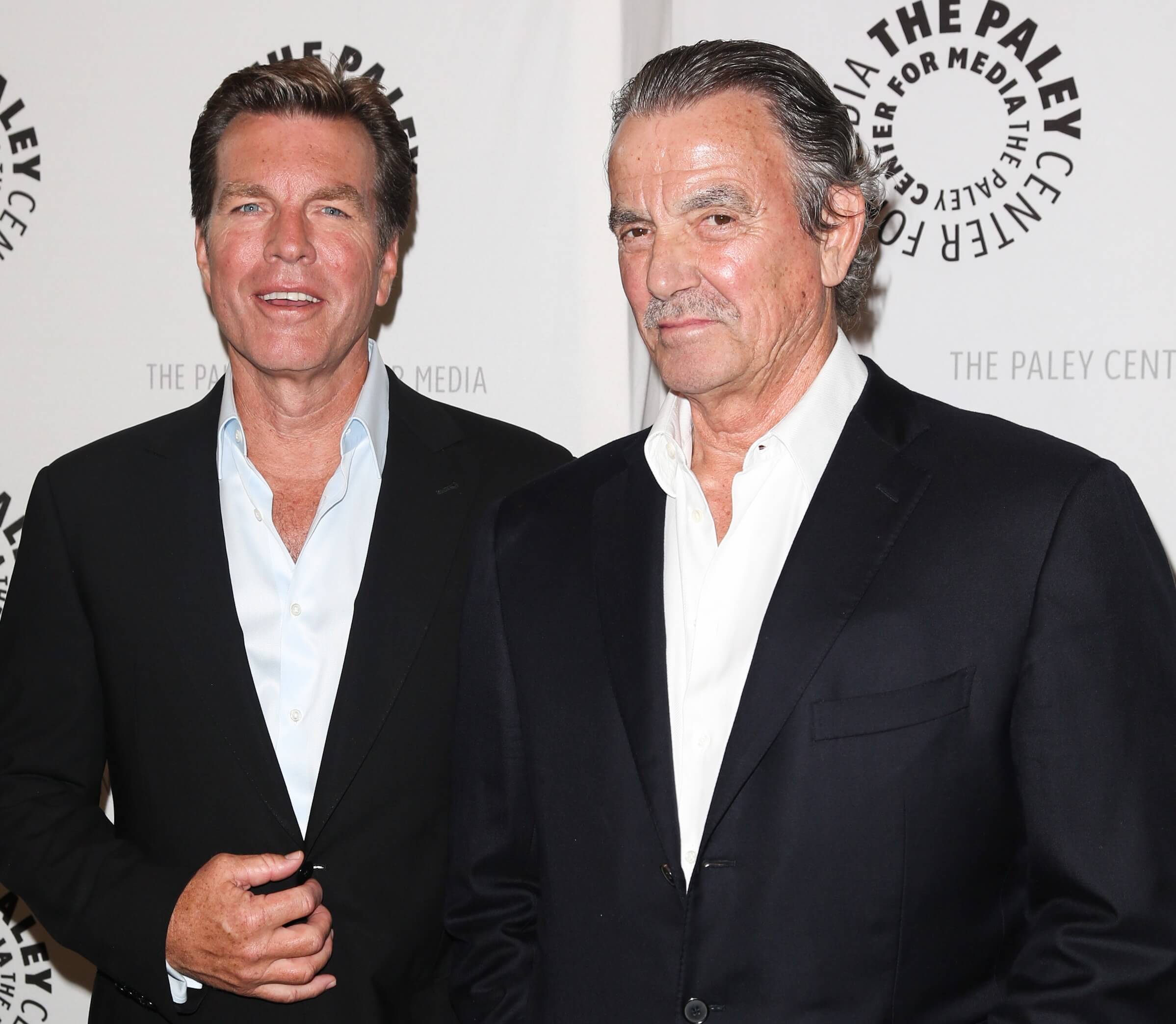 The Young and the Restless stars Peter Bergman and Eric Braeden in black suits;  pose together on the red carpet.