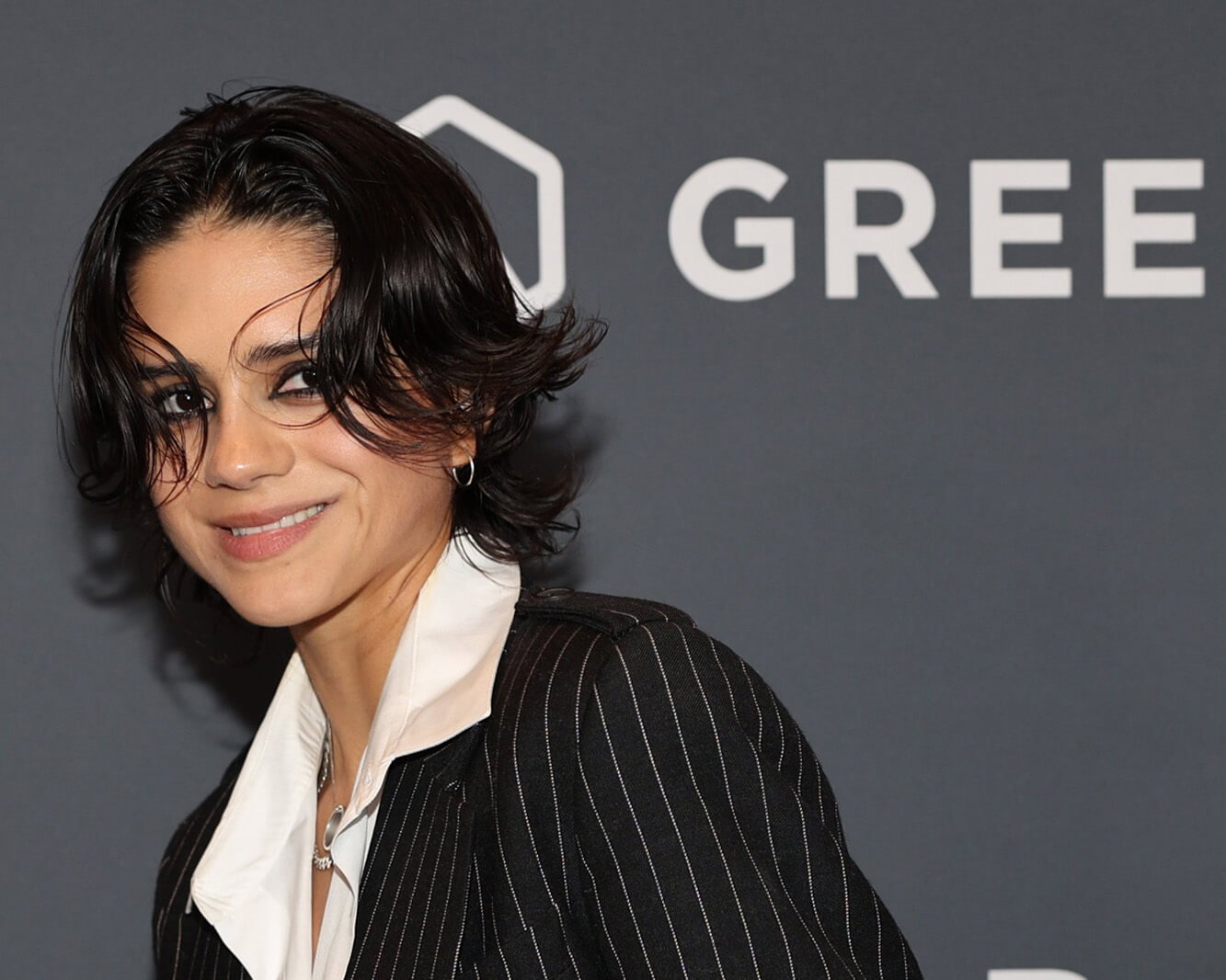 'The Young and the Restless' star Sasha Calle dressed in a black and white striped suit; poses on the red carpet.