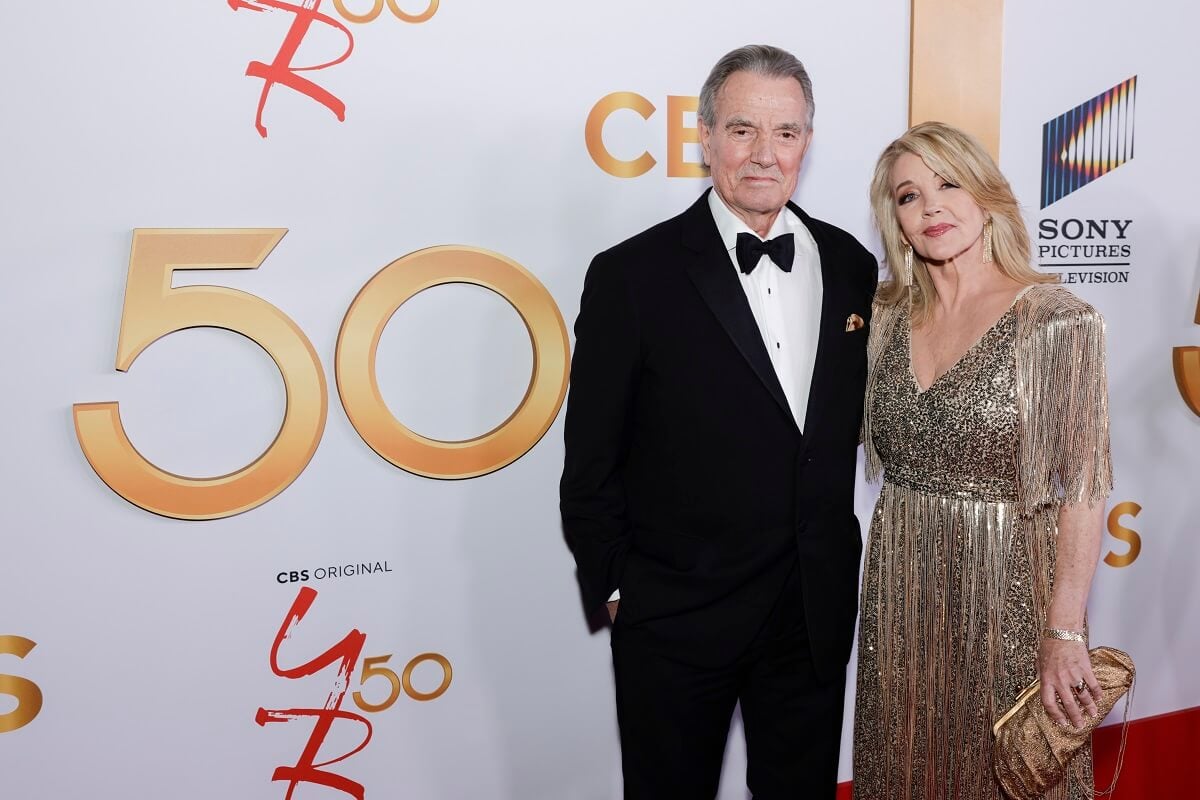 'The Young and the Restless star Eric Braeden in a tuxedo and Melody Thomas Scott in a gold dress; posing on the red carpet for the show's 50th anniversary.