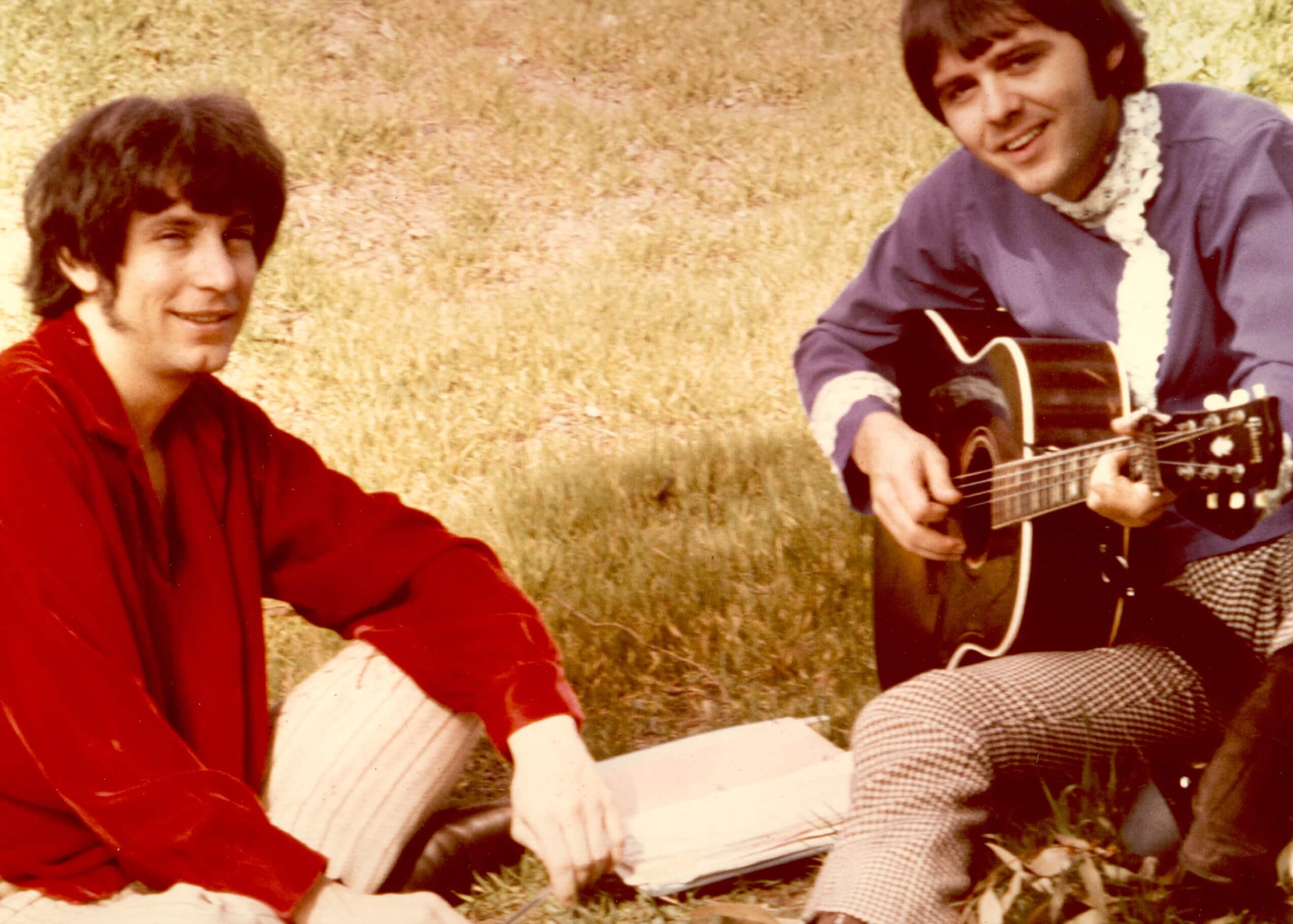 Bobby Hart and Tommy Boyce sitting on grass