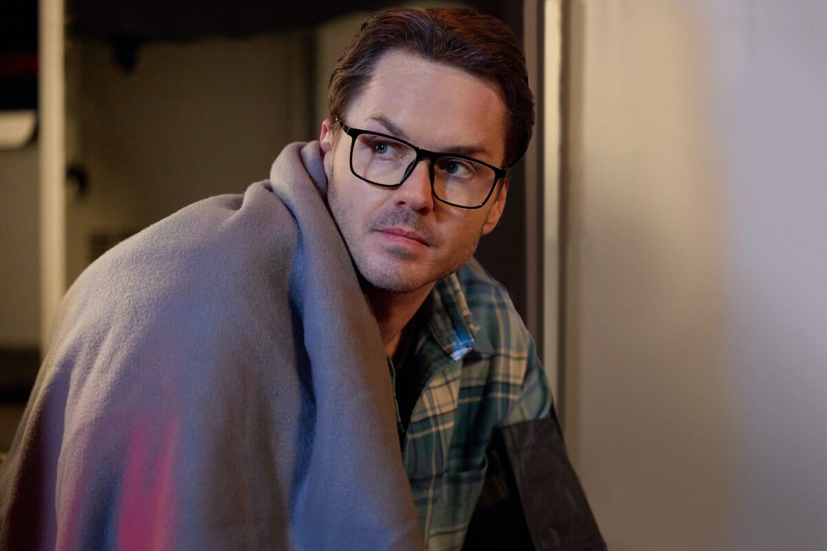 Paul Campbell, wearing glasses, in the Hallmark mystery movie 'The Cases of Mystery Lane'