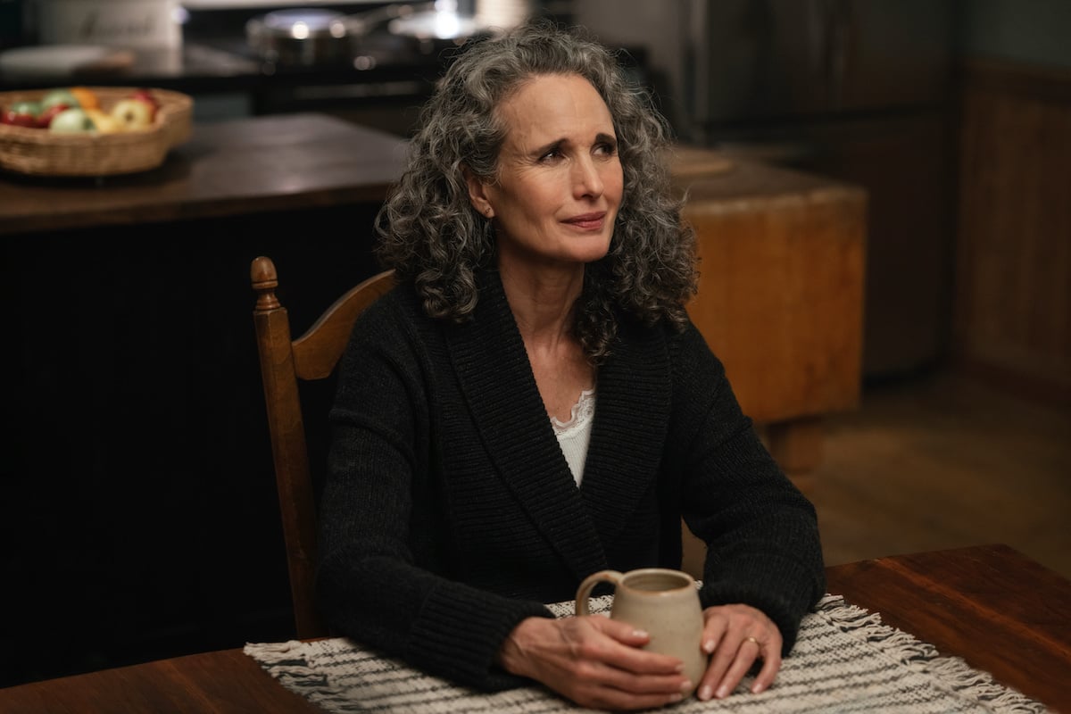 Andie MacDowell sitting at a table in Hallmark's 'The Way Home'