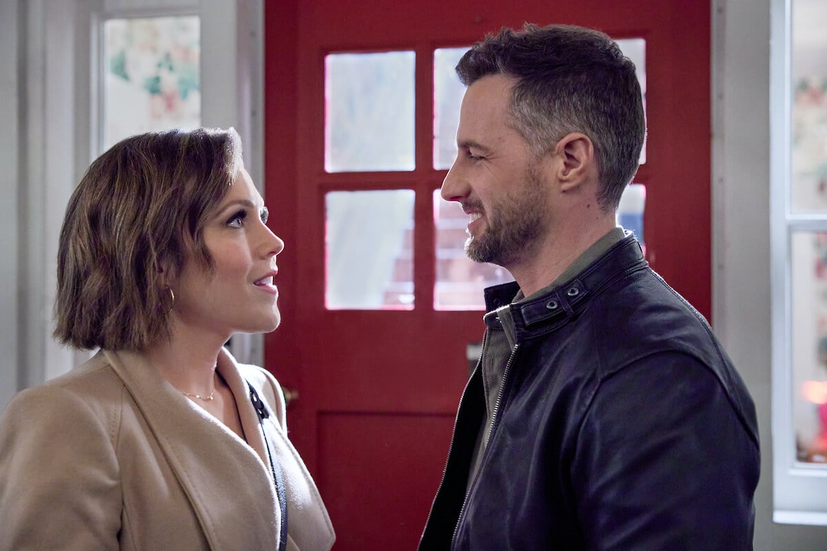 Erin Krakow of 'When Calls the Heart' and Brendan Penny looking at each other in Hallmark's 'The Wedding Cottage'