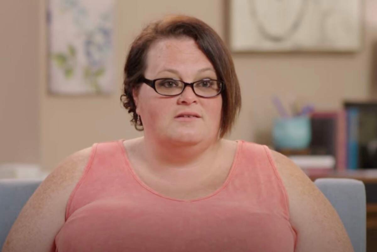 Tina Arnold films an interview for 1000-lb Best Friends wearing a pink tank top