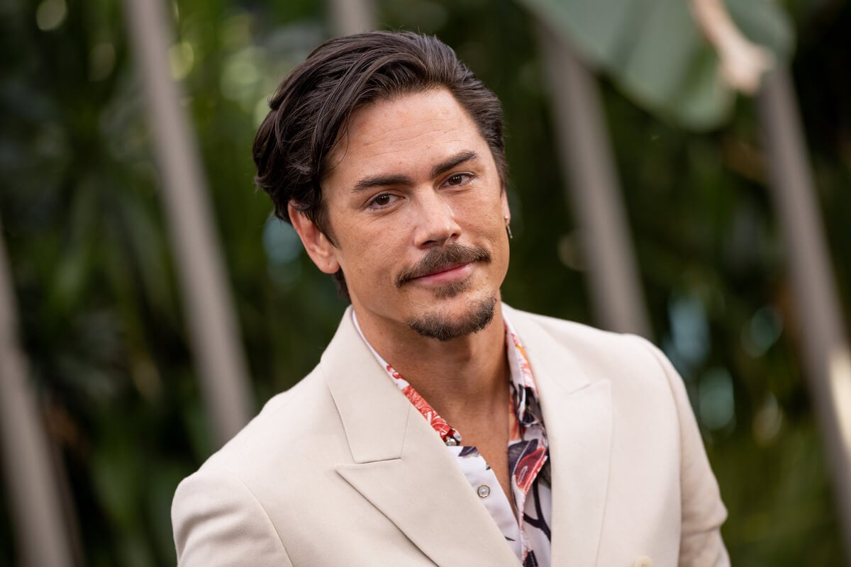 closeup of Tom Sandoval wearing a white suit