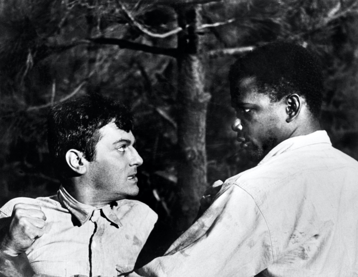 Tony Curtis and Sidney Poitier looking at each other in the 1958 movie 'The Defiant Ones'