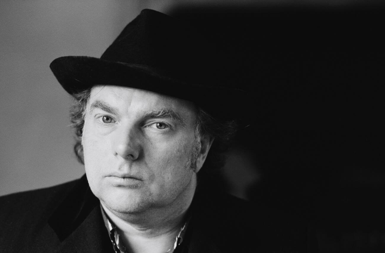 A black and white picture of Van Morrison wearing a fedora.