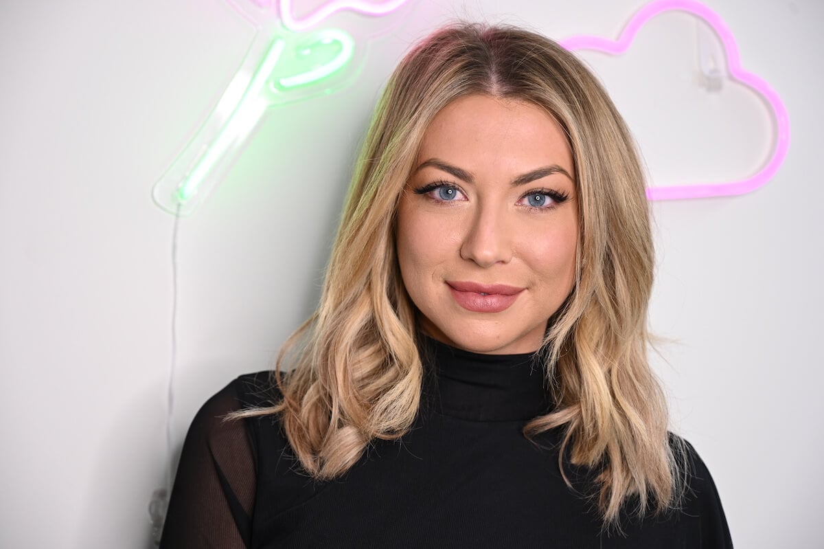 "Vanderpump Rules" star Stassi Schroeder smiles and poses at an event.