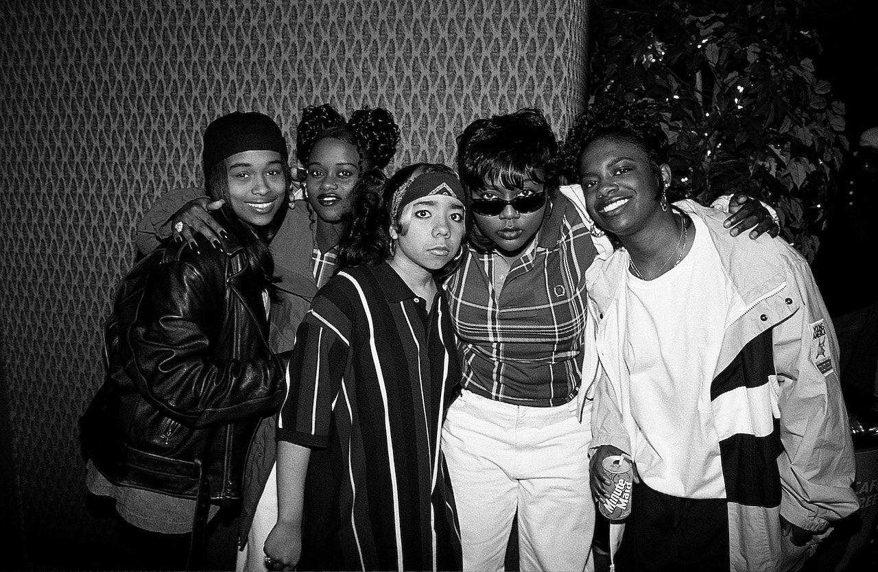 XSCAPE and TLC pose for photo; Kandi Burruss and Tiny Harris of XSCAPE wrote TLC's "No Scrubs" but met Left Eye years prior.