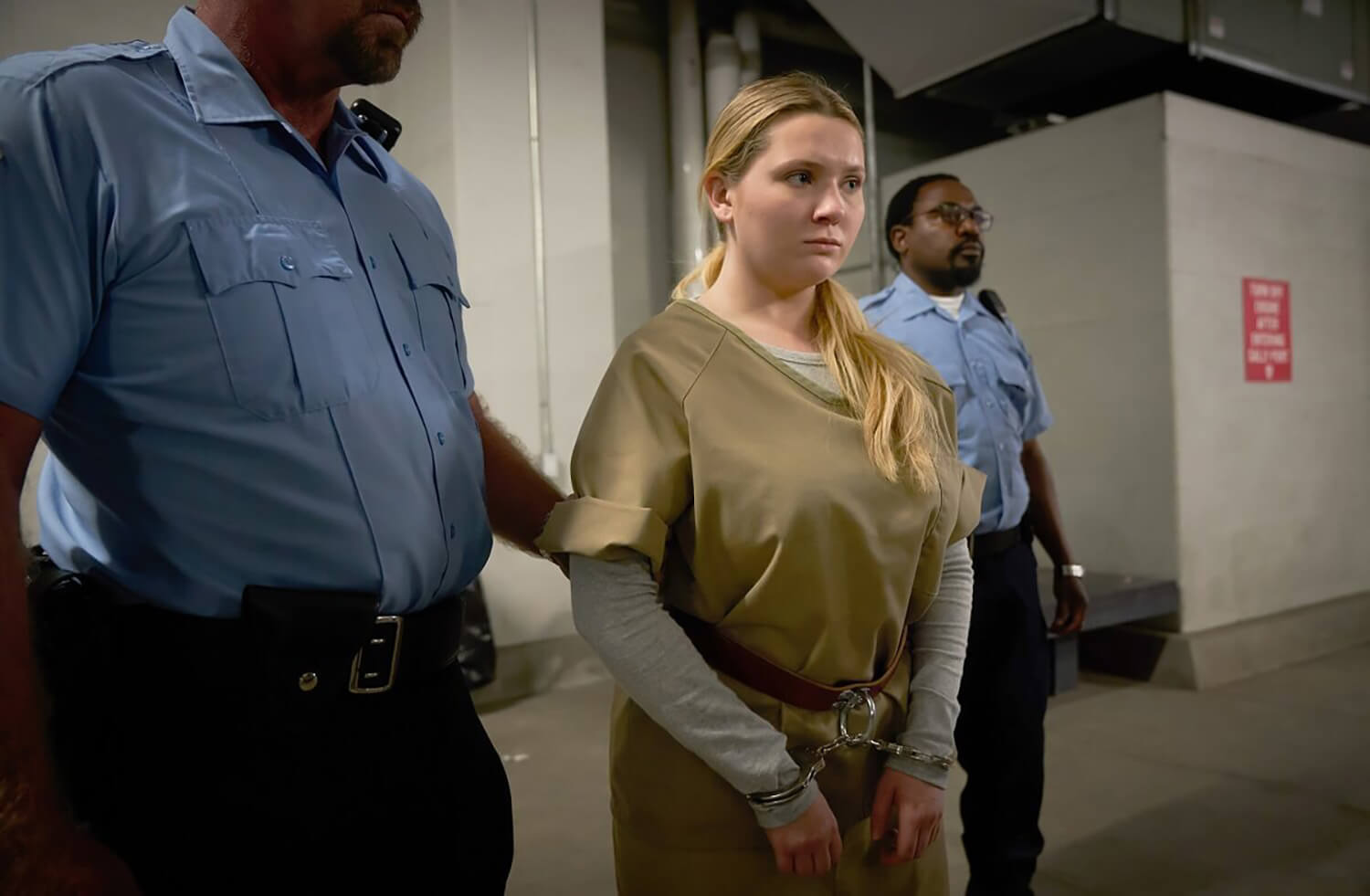Accused Episode 10 cast member Abigail Breslin as Esme, escorted by two cops.