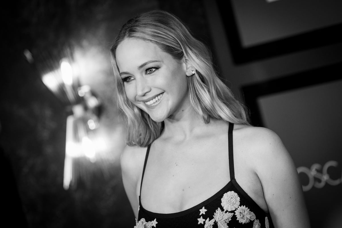 acting star Jennifer Lawrence smiles is a spaghetti strap dress