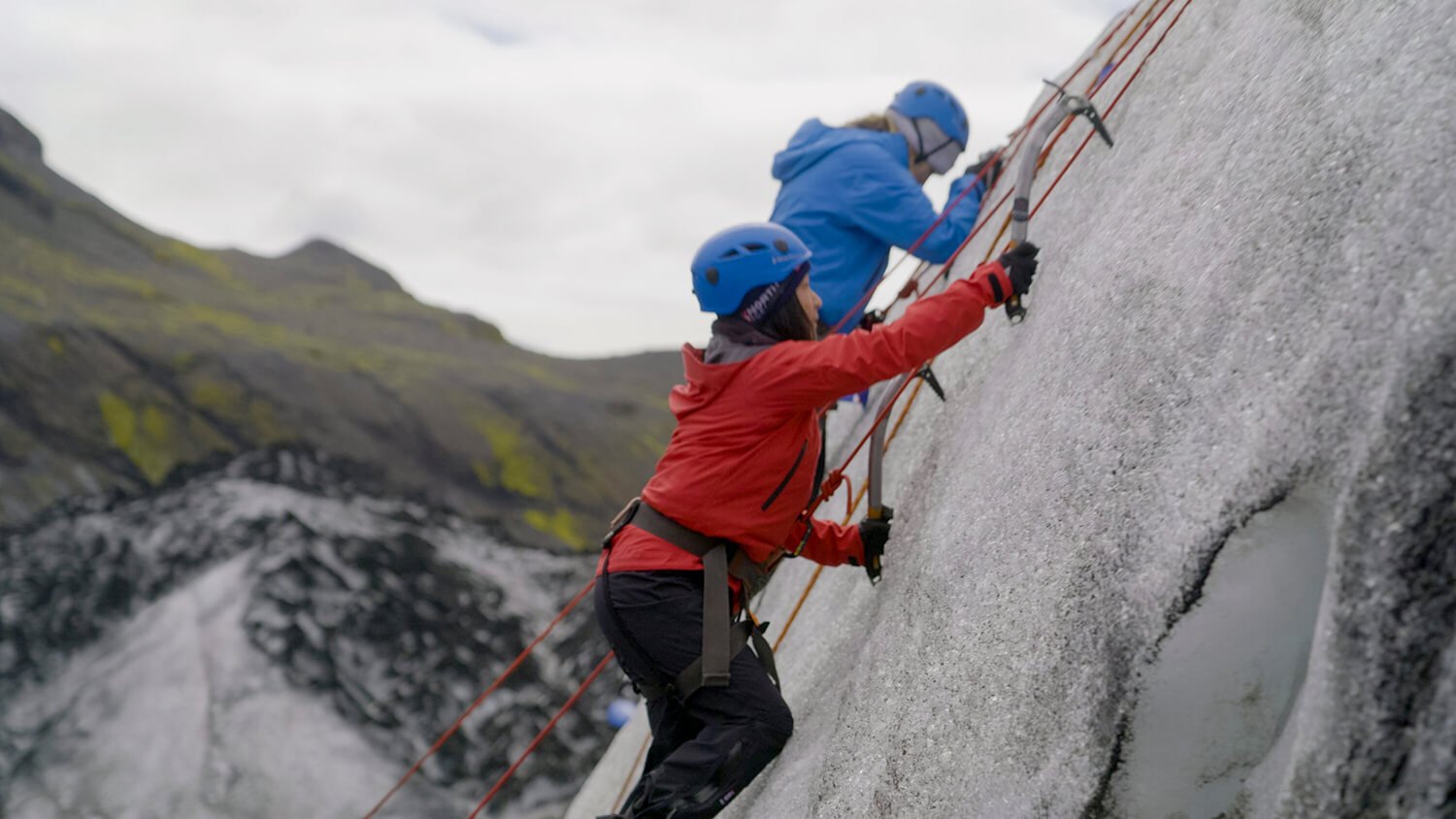 The Amazing Race 34: Emily Bushnell and Claire Rehfuss scale a cliff wearing red and blue sweatshirts and blue helmets