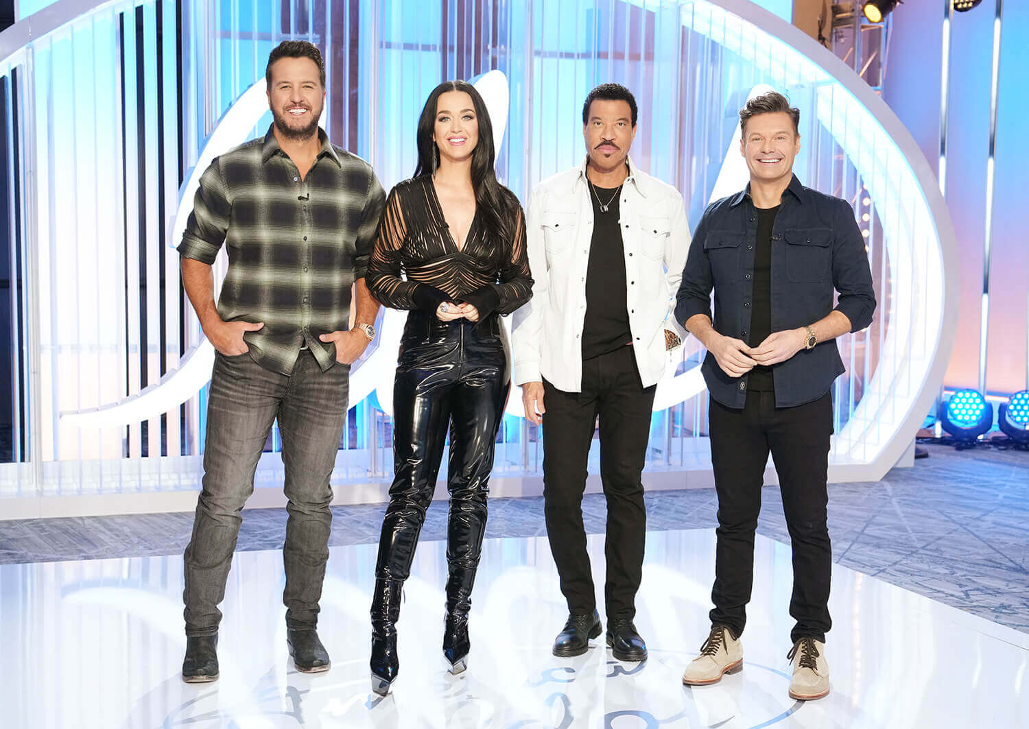 American Idol 2023 judges Luke Bryan, Katy Perry, Lionel Richie, and host Ryan Seacrest stand together in the audition room