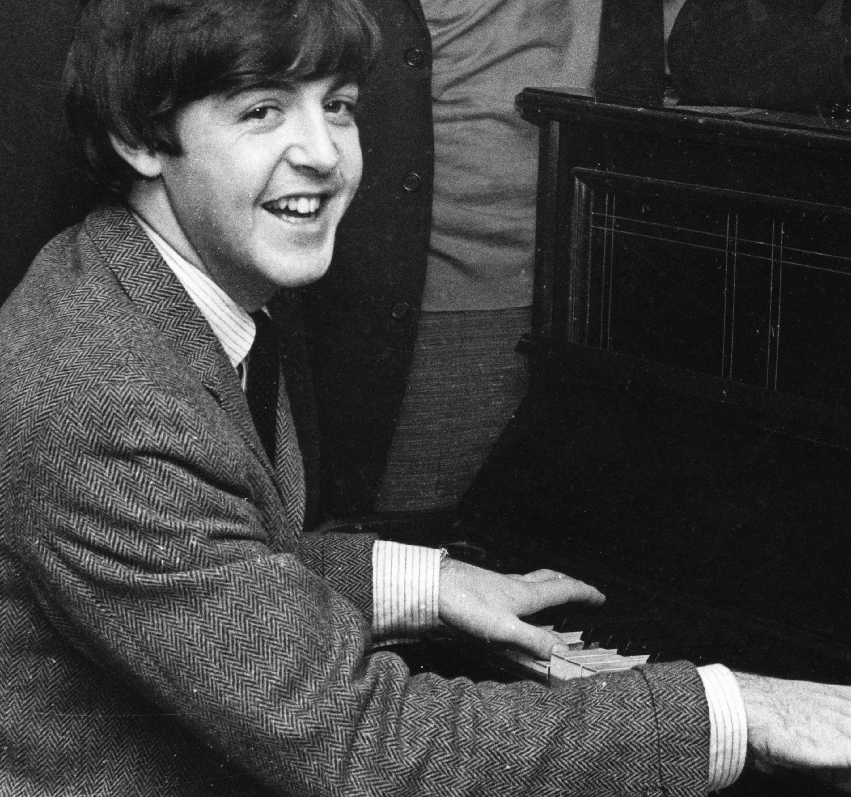 The Beatles' Paul McCartney playing a piano
