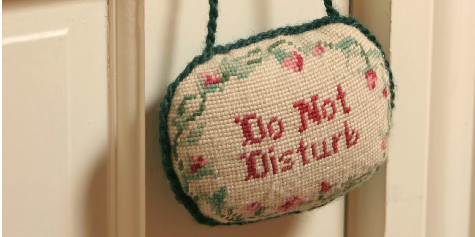 A do not disturb sign hanging on a doorknob.