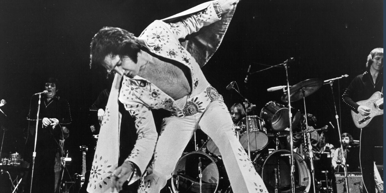 Elvis Presley wears an embellished, white jumpsuit at a 1972 concert.