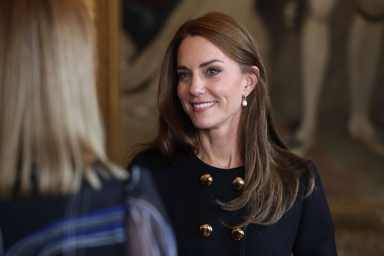 Kate Middleton smiles while wearing her hair down