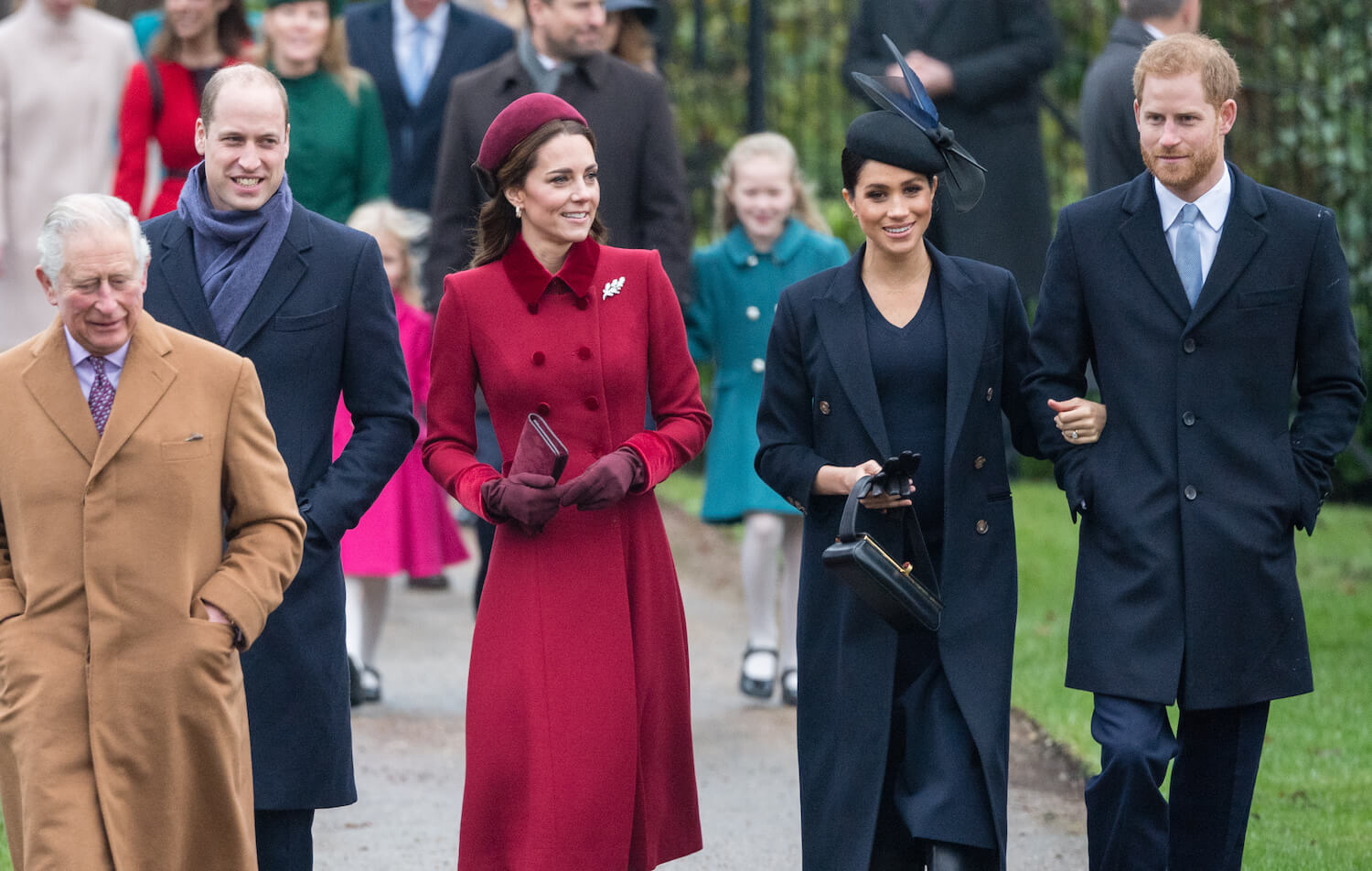 King Charles walks with Prince William, Kate Middleton, Meghan Markle, and Prince Harry outside
