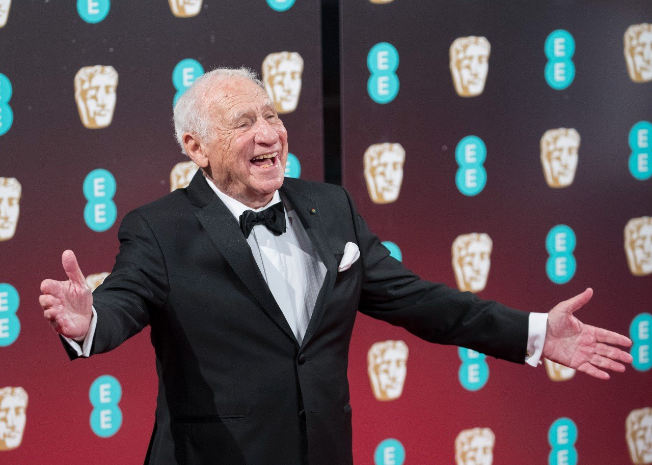 Mel Brooks holds his hands out during an event.